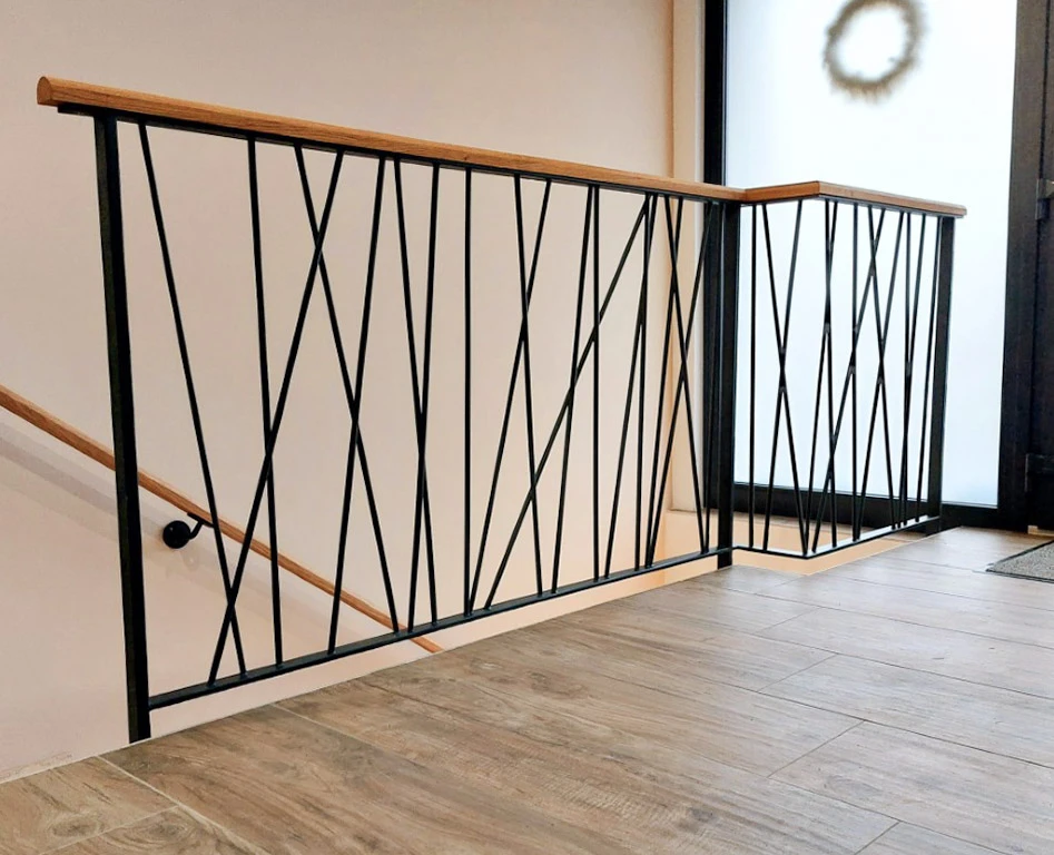 Portail en fer forgé blanc artistique avec motifs végétaux ondulants, installé entre piliers maçonnés
